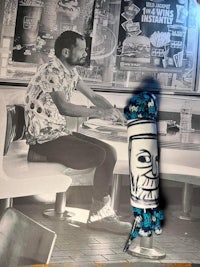 a photo of a man sitting at a table in a restaurant