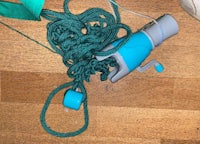 a blue and green rope on a wooden floor