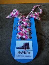 a tag with a pink and grey yarn on it